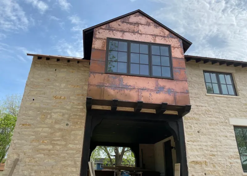 Copper metal panel facade on a stone building for Metal Roof Coating in Jersey Village