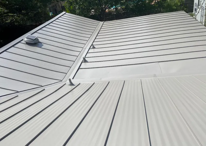 Solar attic fan installed on a metal roof for Roof Ventilation in Jersey Village
